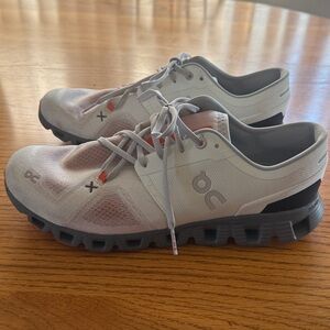 On Running White and Black Athletic Shoes